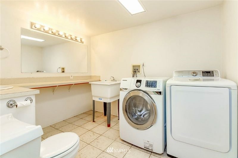 Shared bathroom in the basement with laundry