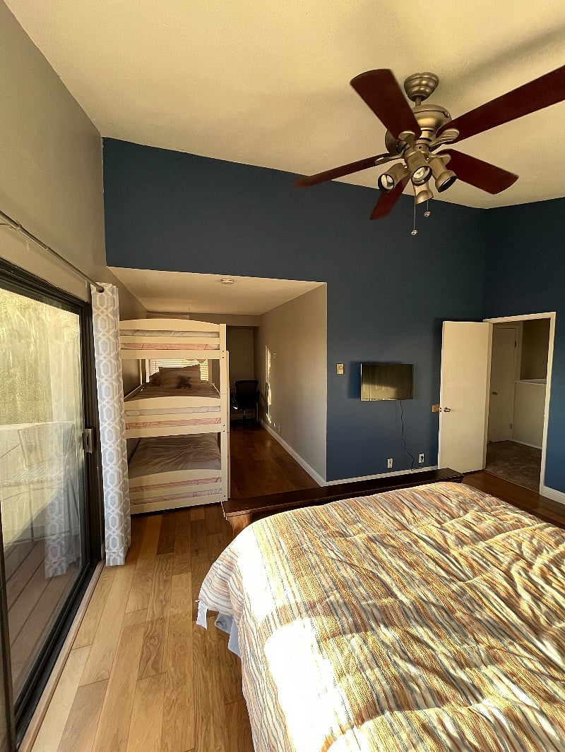 Bedroom #1- TV facing the queen bed, triple bunkbed in the nook along with small moveable/folding work desk 