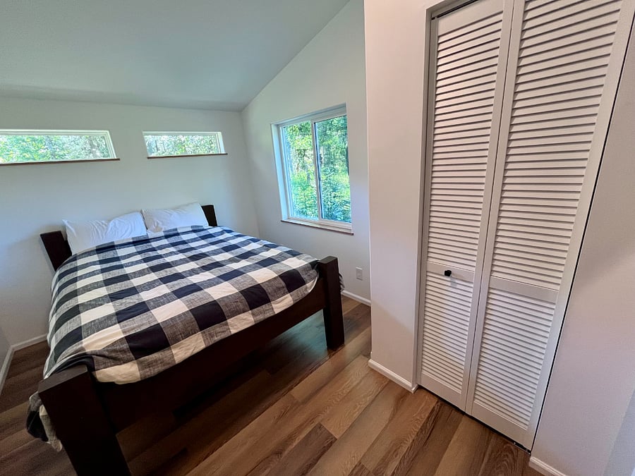 The bedroom provides storage options including a amply sized dresser and an ensuite closet. ***Blackout curtains available for the Midnight Sun***