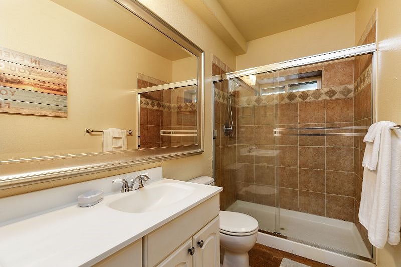 Bright, clean bathroom with a spacious double-shower-head setup and an oversized mirror, perfect for refreshing before shifts and unwinding after them.