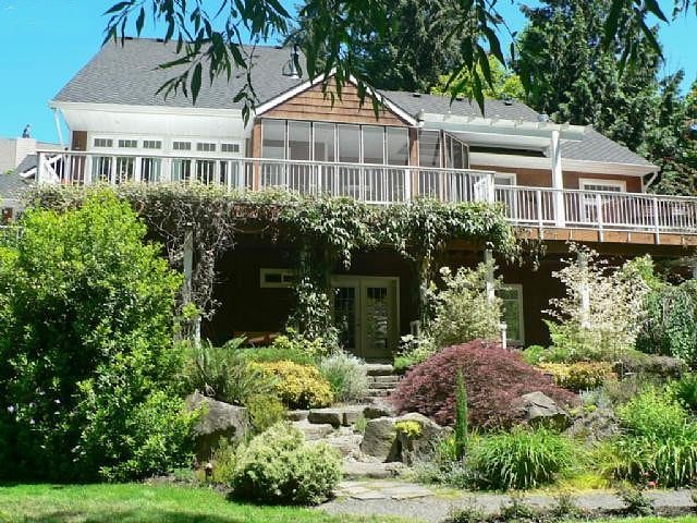Exterior view of the property with your spacious private lower patio nestled among the gardens and perfect for quiet breaks between shifts.