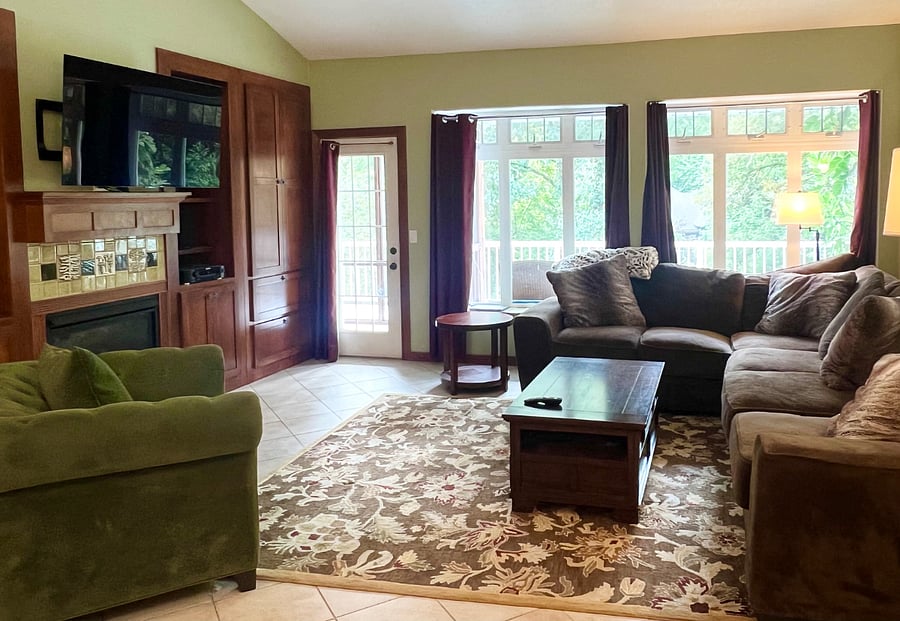 Large open common area, with living room area, and door out to the screened in porch for morning coffee listening to the trickle of the Kellogg Creek.
