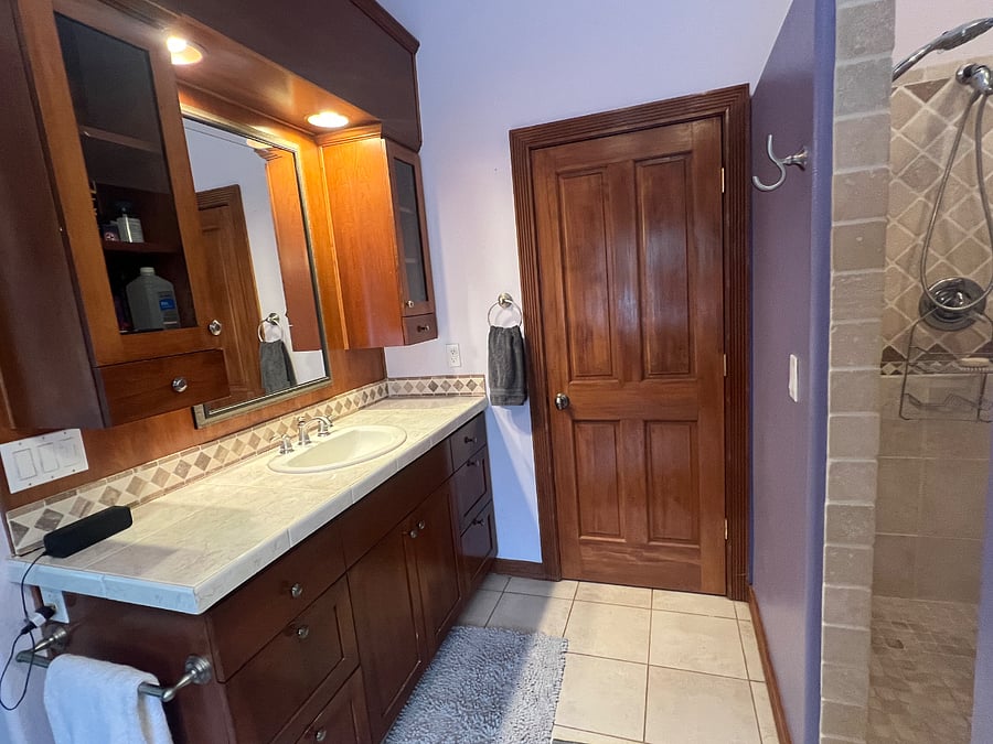 Master bath with vanity and walk in shower with two shower heads. Point of use hot water means the hot water never runs out!