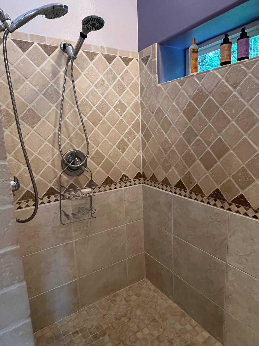 Master bath shower with double shower heads.