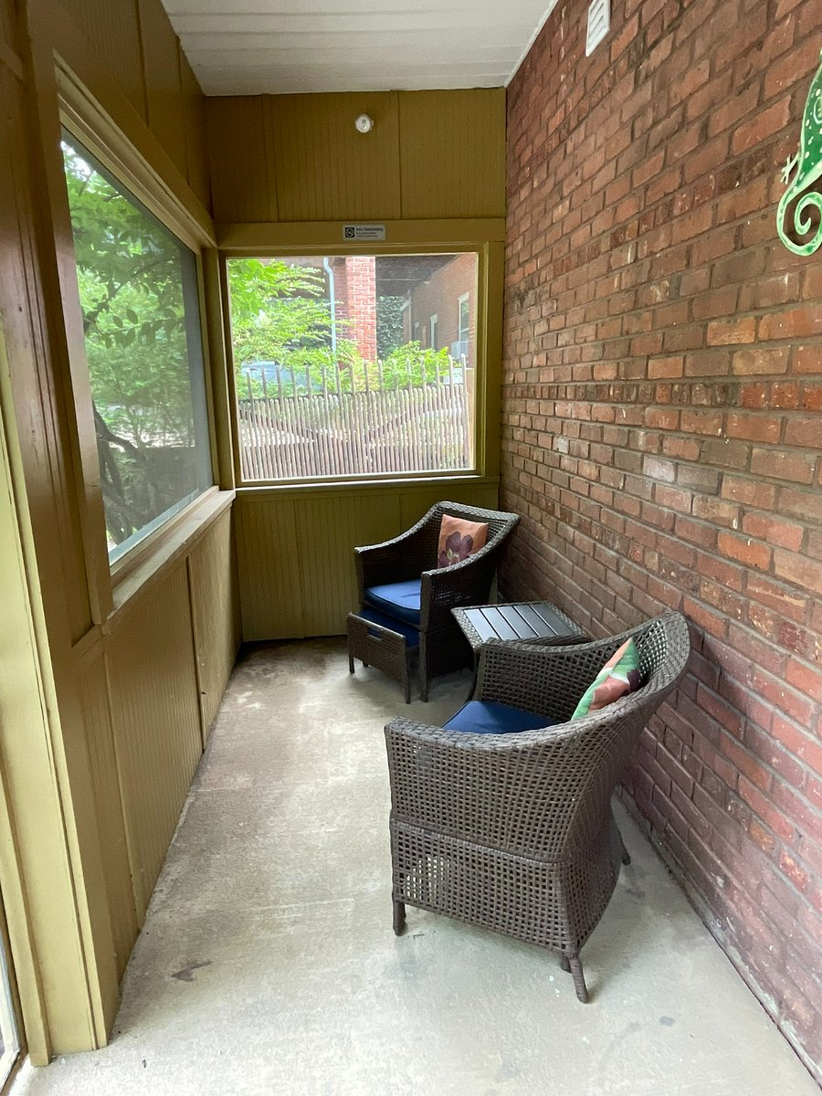 Screened in porch with sitting area