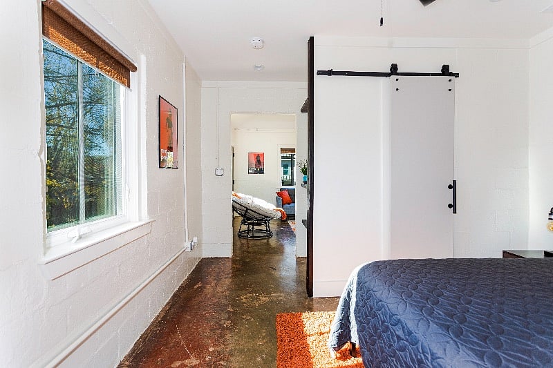 View from bedroom to the living room. Note sliding barn door to your walk-in closet.