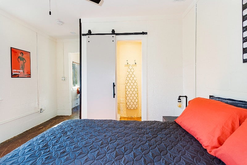 Walk-in closet through sliding barn door. 