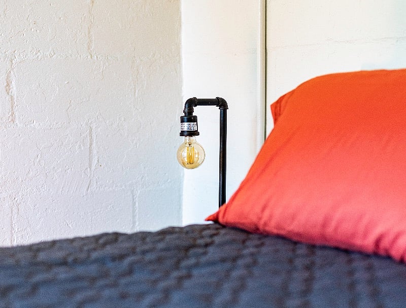 The dimmable industrial table lamps have USB charging ports.