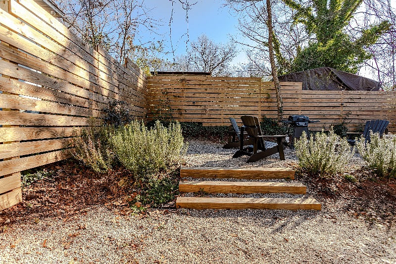 Fenced backyard with privacy slats.
