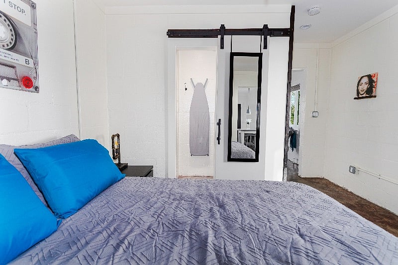 Walk-in closet through sliding barn door. 