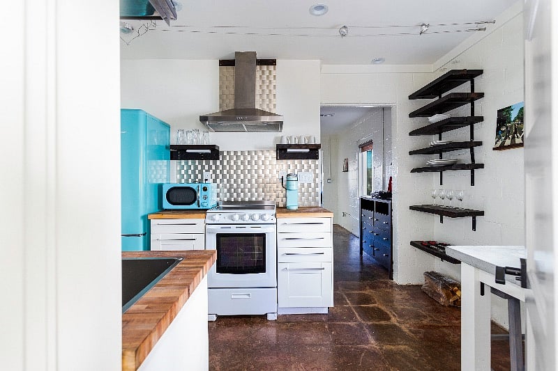 Full kitchen, fully stocked for cooking and baking. View toward bedroom.