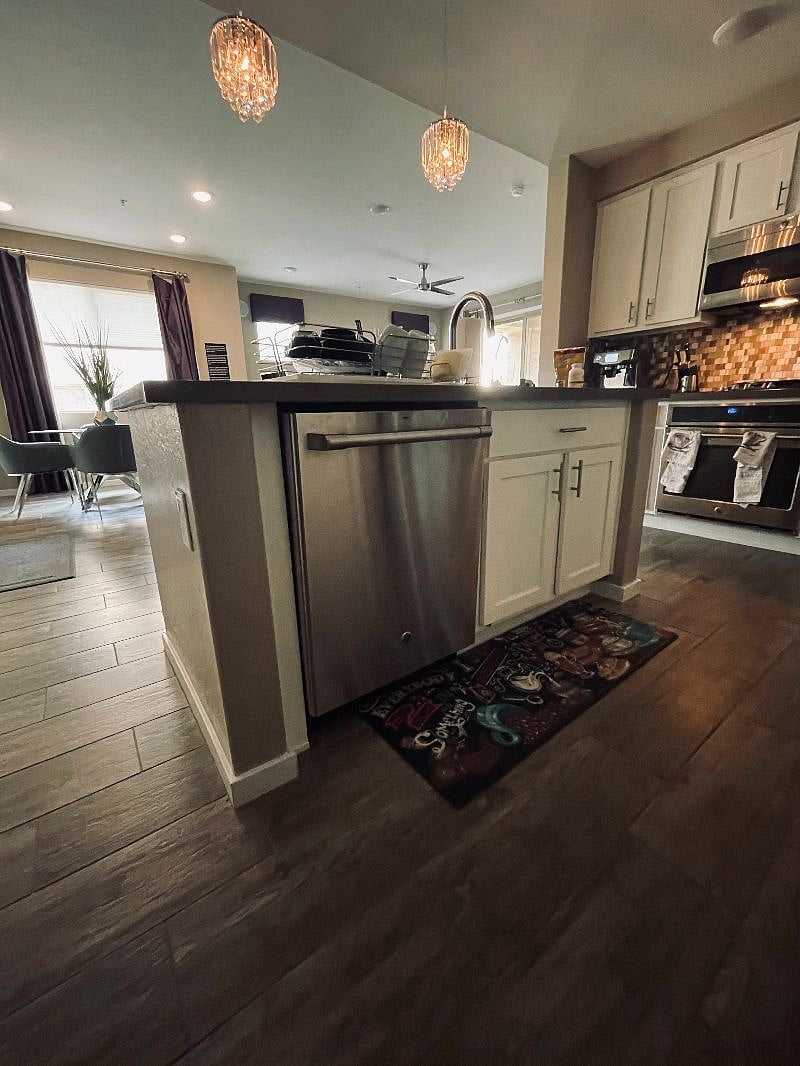 Kitchen with deep sink, garbage disposal, large refrigerator, pantry, microwave, convection oven, stove, and dishwasher