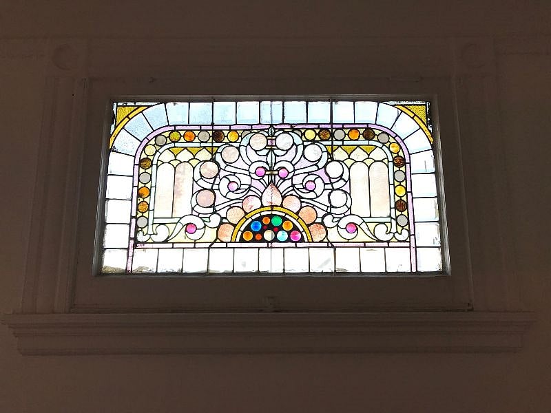 Original 1892 stained glass window in bedroom