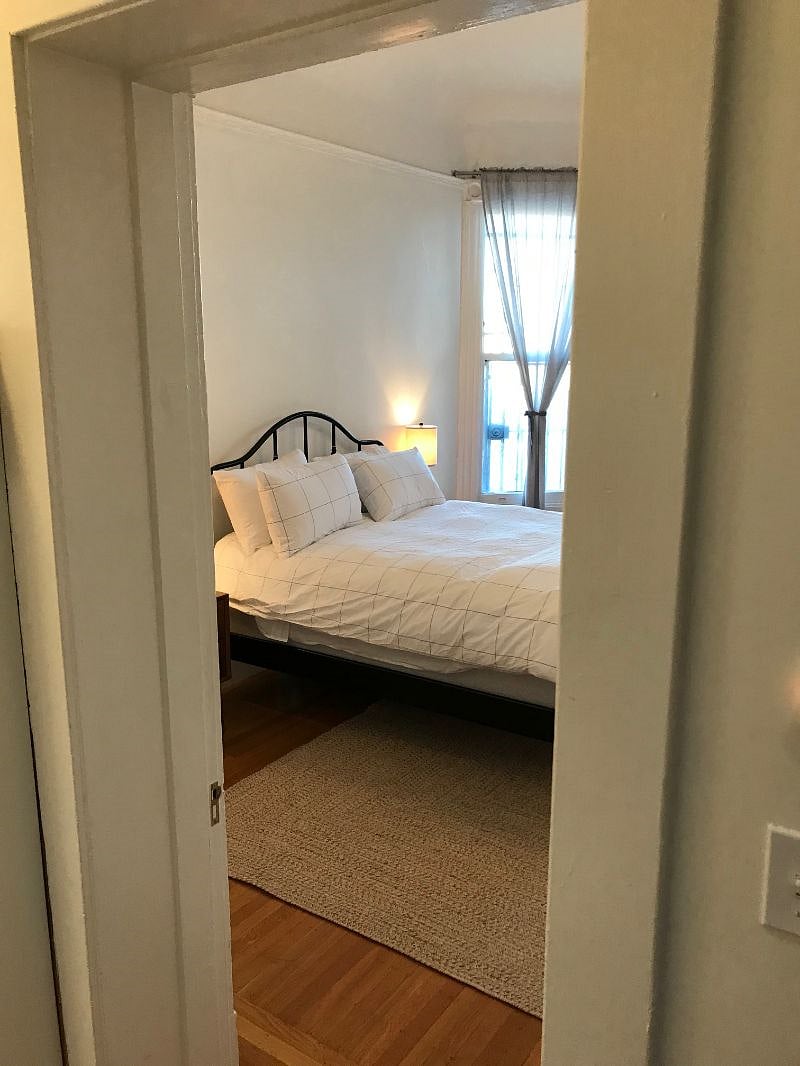 Large, well-lit bedroom with new linens, ample storage, and big closet