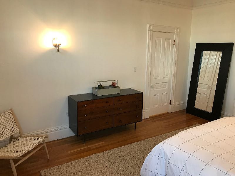Large, well-lit bedroom with new linens, ample storage, and big closet