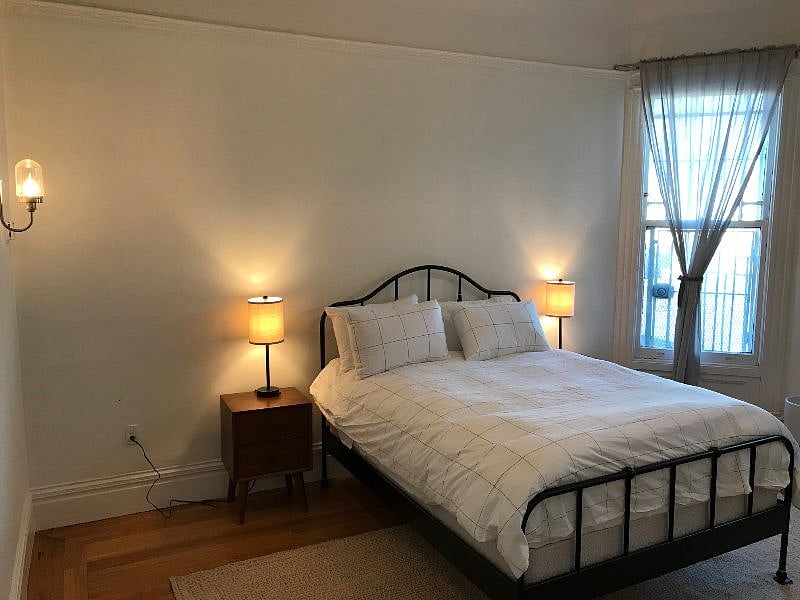 Large, well-lit bedroom with new linens, ample storage, and big closet