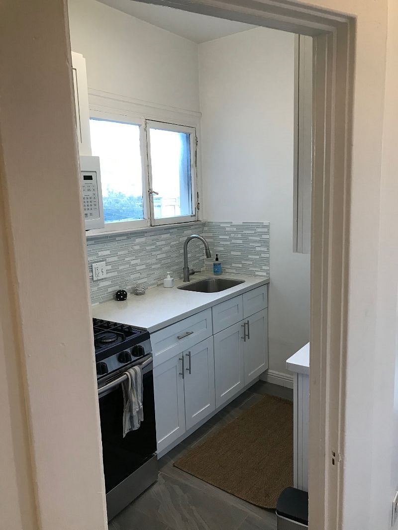 Galley-style full kitchen with dishes