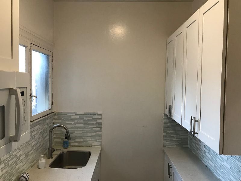 Galley-style full kitchen with dishes