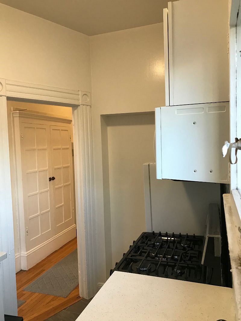 Galley-style full kitchen with dishes