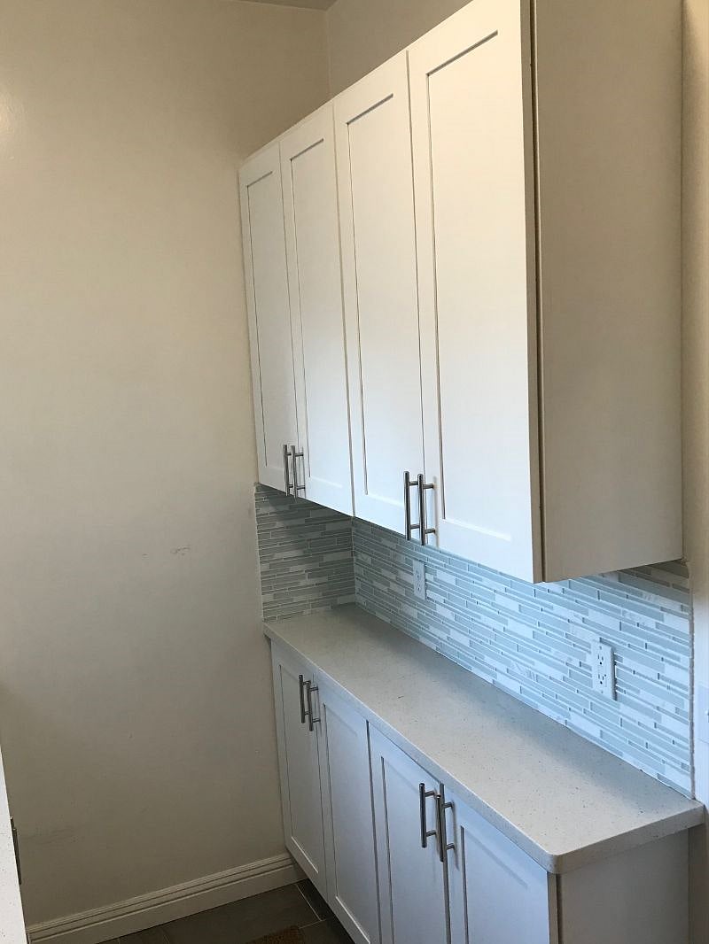 Galley-style full kitchen with dishes