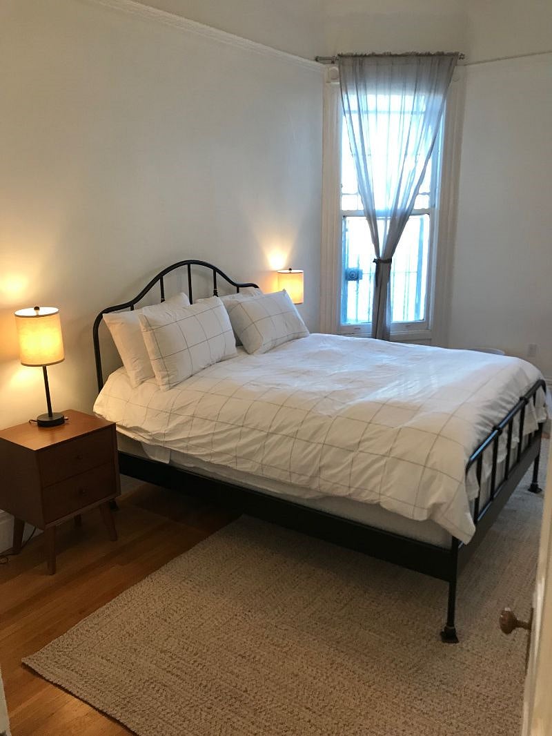 Large, well-lit bedroom with new linens, ample storage, and big closet