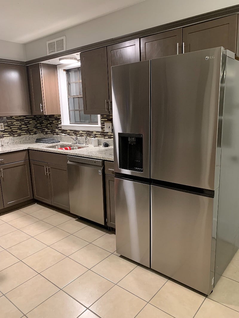 Stainless Steel refrigerator/freezer, and dishwasher in the kitchen.