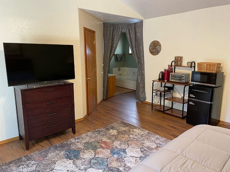 Bedroom with smart TV and dresser