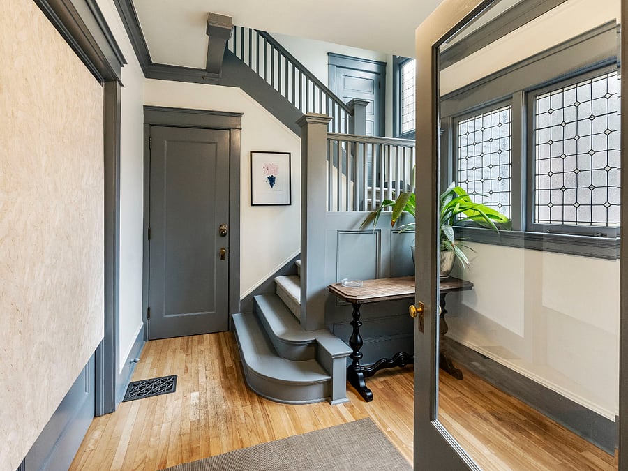 Inside the front door, up the stairs to the top-floor apartment.