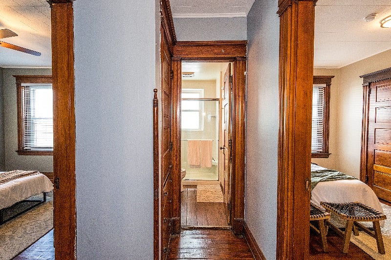 Both bedrooms with the bathroom in-between and a built-in linen closet in the hallway.