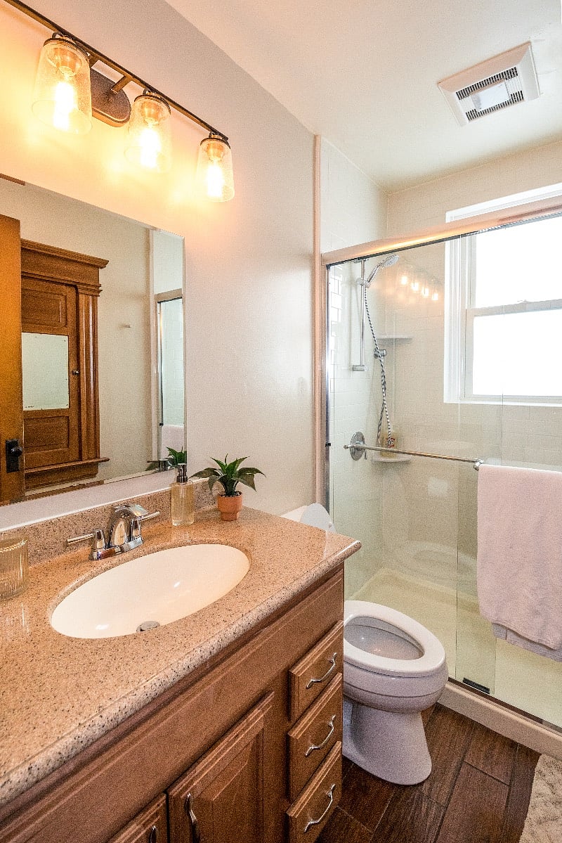 Fully stocked bathroom with linens, soap, and a standing shower (no tub).