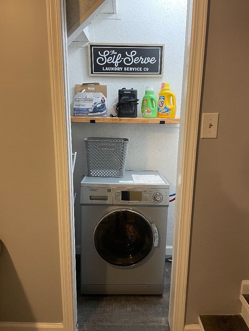 Laundry closet with all in one washer and dryer unit.