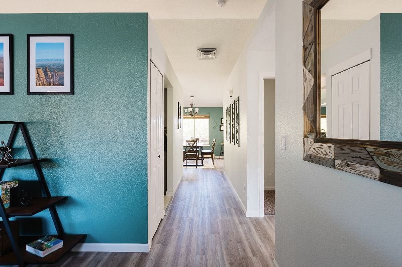This is the view from the front door. You can see the open space concept right away. One of the living areas is on the left, two bedrooms to the right, dining area straight ahead, and kitchen, second living area, and master suite to the left.