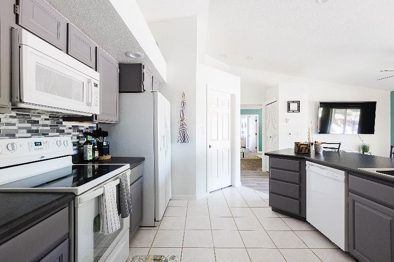 A view of the open concept kitchen. Enjoy the new sink and countertops, along with the freshly painted cabinets.
