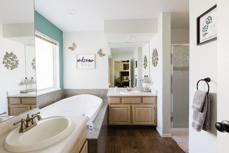 The master bath with two separate sinks, tub, and full size shower.
