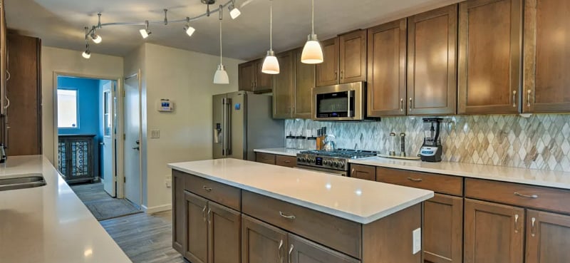 Fully stocked cooks kitchen includes a professional gas range, large prep island, and quartz counters.