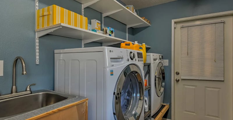 Utility room with laundry detergent included.
