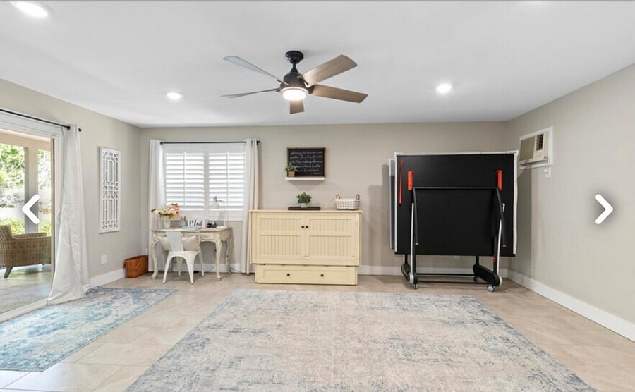Game room with desk, queen size Murphy bed and ping pong table.