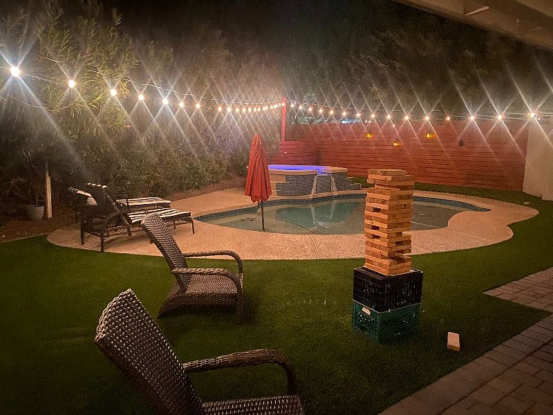 beautiful backyard oasis with heated pool and hot tub. 