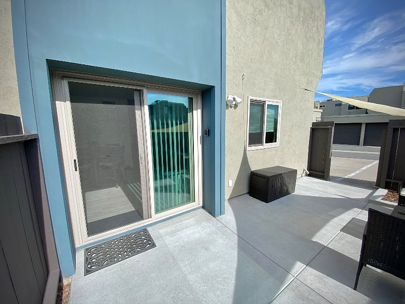 Patio area with sliding glass door and parking spot access thru the gate