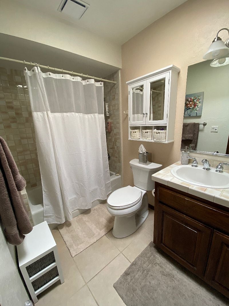 The hall bathroom for the second bedroom with a wall heater