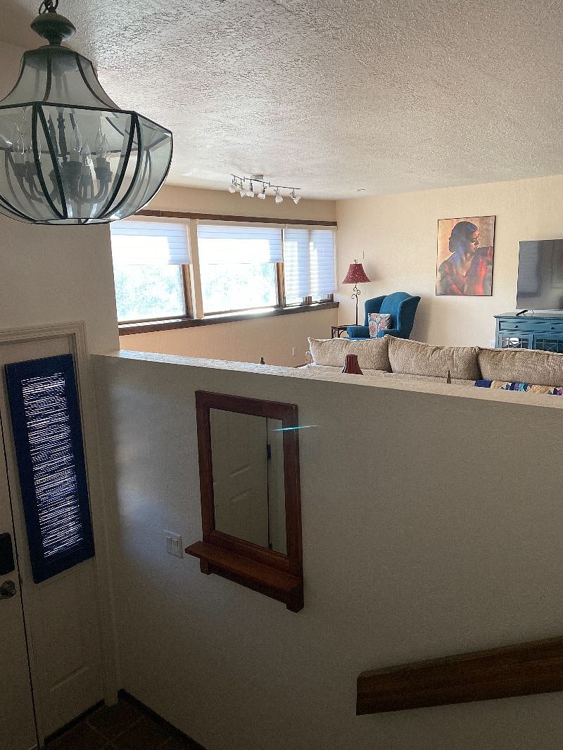 Peeking through the kitchen opening over the entry and into the living room.
