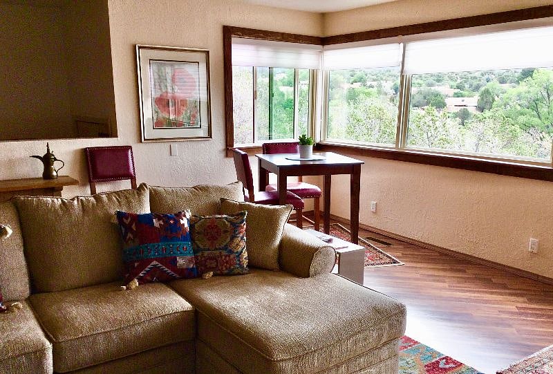 A bistro table added to the living room: a lovely breakfast spot, or eating while watching the 65" TV!
