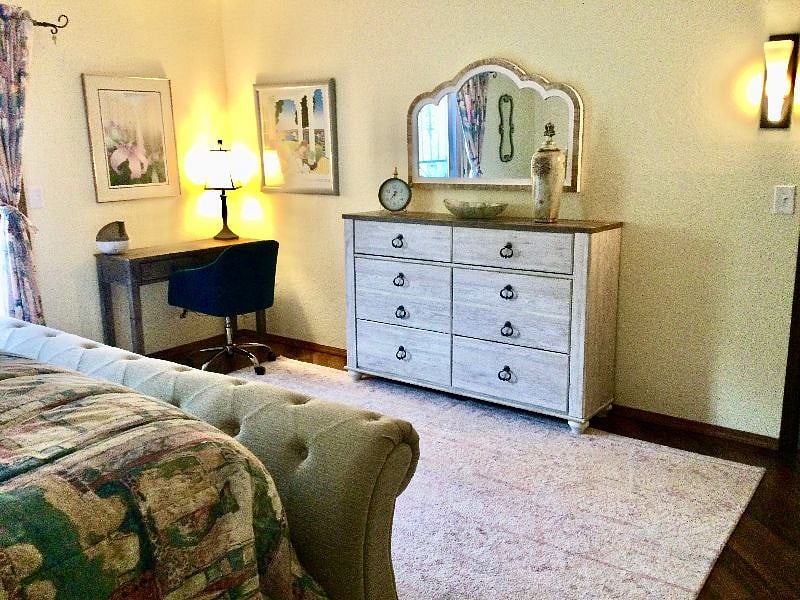 The master suite has a small writing desk and a comfy chair!