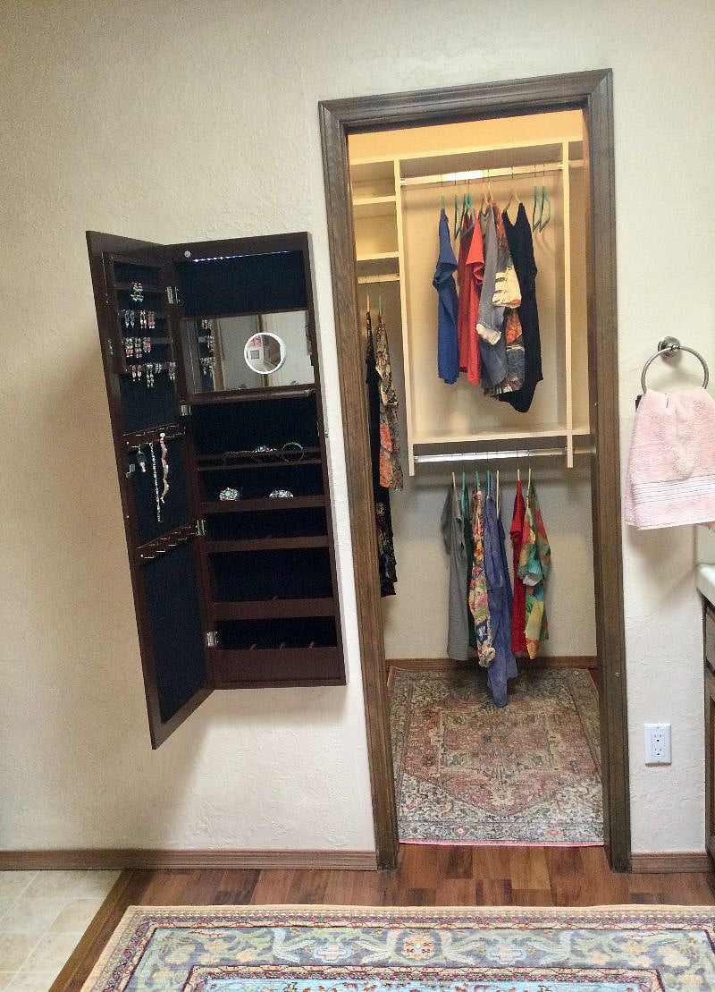 The jewelry cabinet is a long mirror when closed.