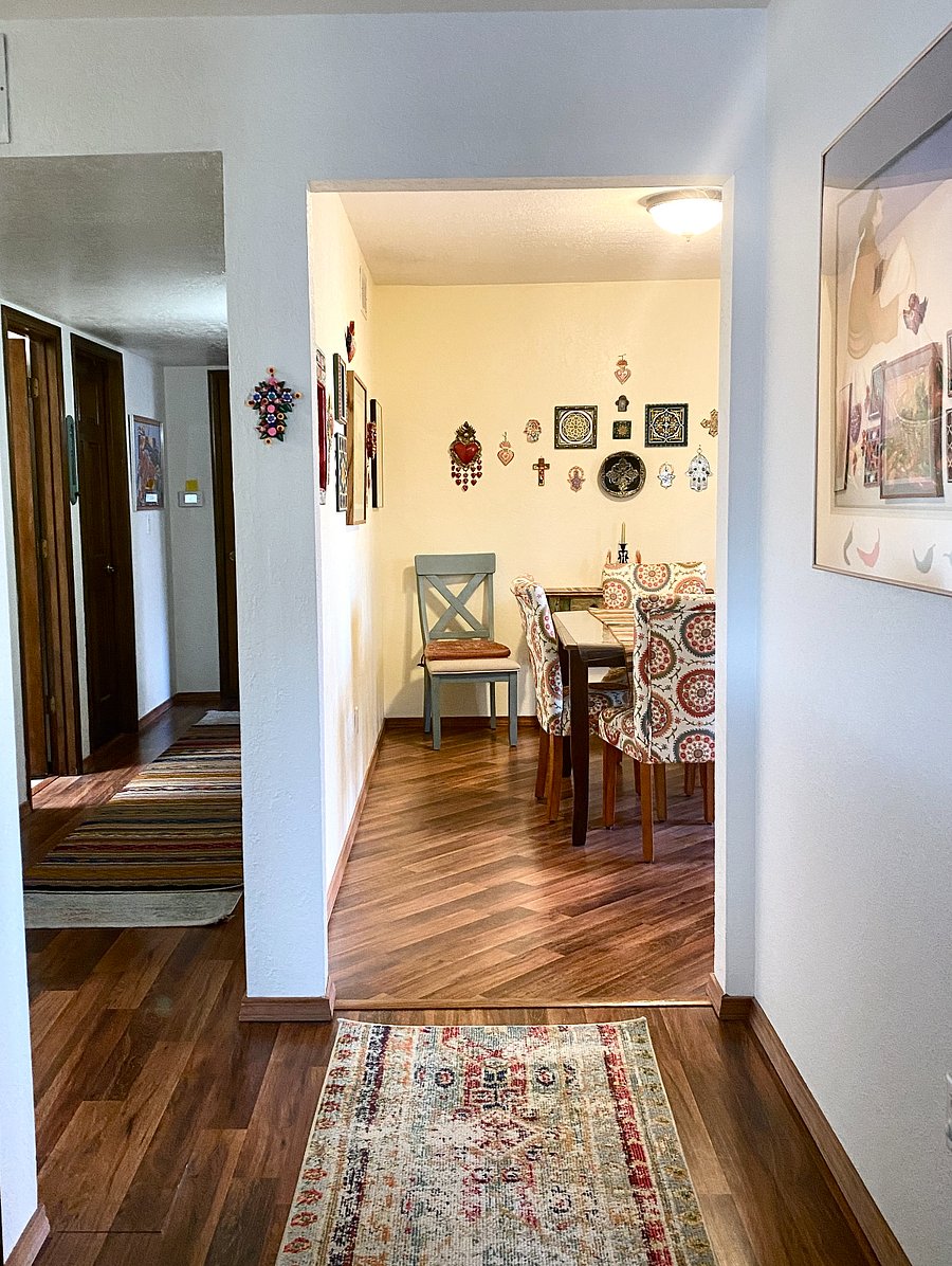 Straight ahead is the dining room. The hallway to the bath and bedrooms is to the left. The living room is a hard left.