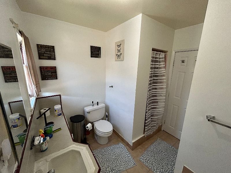 The bathroom has what a typical bathroom would have. Sink, toilet, cabinets. There is a stand-up shower just as you enter the bathroom on the right, and there also is a tub...where this photo was taken from.