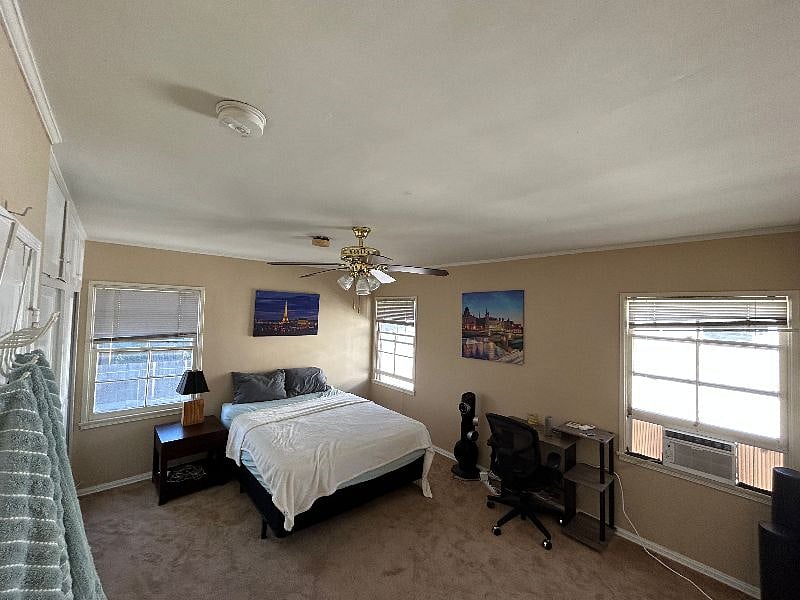 The master bedroom, entering from the hallway. Large bedroom, newly painted walls, and brand new carpeting as of Summer 2023. Also, a brand new window AC unit as of Summer 2023.