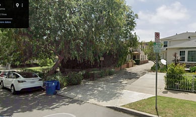 The home itself, which the owners have converted into a 3-unit triplex, is largely hidden from view behind this large tree. My place is the only upstairs unit of the 3, and there is a private entry into the apartment if you walk down the driveway and then go up about 12 stairs to get to my front entry. Also, at the back of the parking lot is your dedicated parking space.