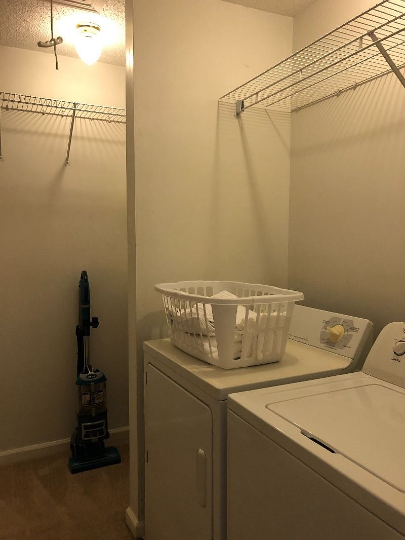 Washer and dryer located in closet in primary bedroom