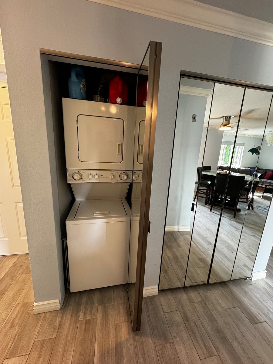 Spacious storage pantry behind bi-fold mirror doors 